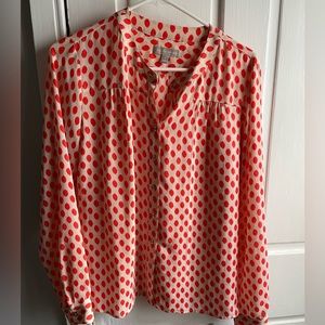 Banana Republic orange-patterned blouse on beige background